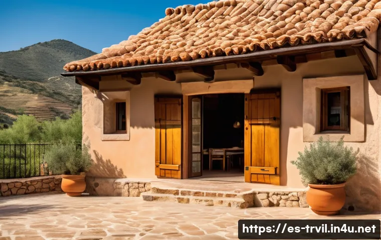 전통주택과 환경 고려 사항 - A traditional Spanish rural house made of adobe, stone, and wood materials, showcasing thick walls a...